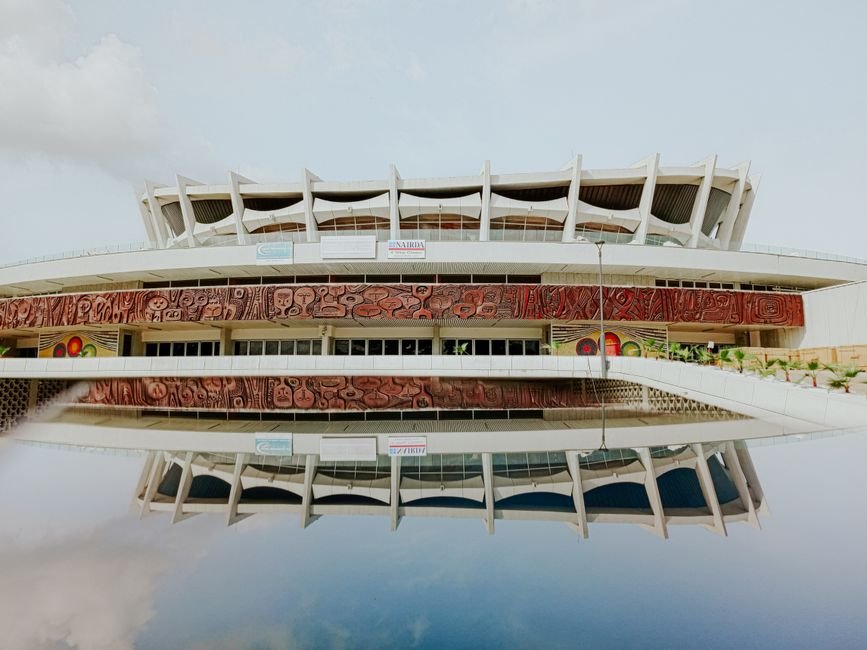 The iconic National Theatre in Lagos, Nigeria, beautifully reflected in still water.