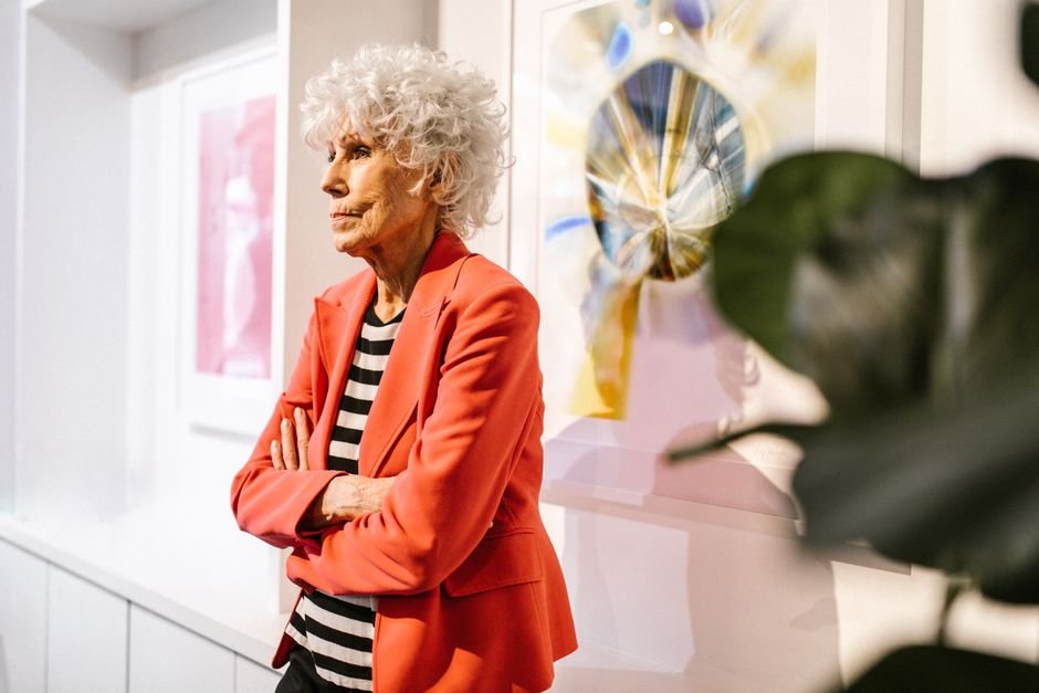 Senior woman in a modern art gallery wearing a stylish outfit, embodying elegance and confidence.