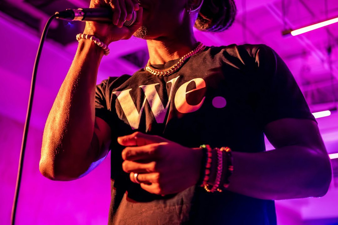 A man standing in front of a microphone on a stage